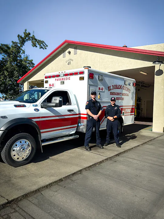 Two paramedics stand by an ambulance outside Station 48, part of El Dorado County's emergency medical services.