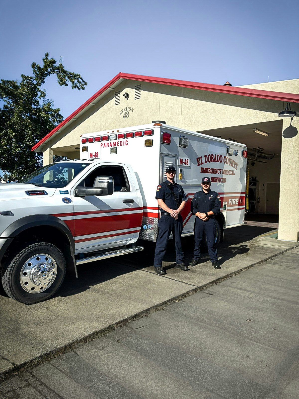 Two paramedics stand by an ambulance outside Station 48, part of El Dorado County's emergency medical services.