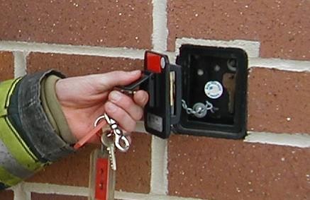 May contain: person and human, keys and lock box on brick wall