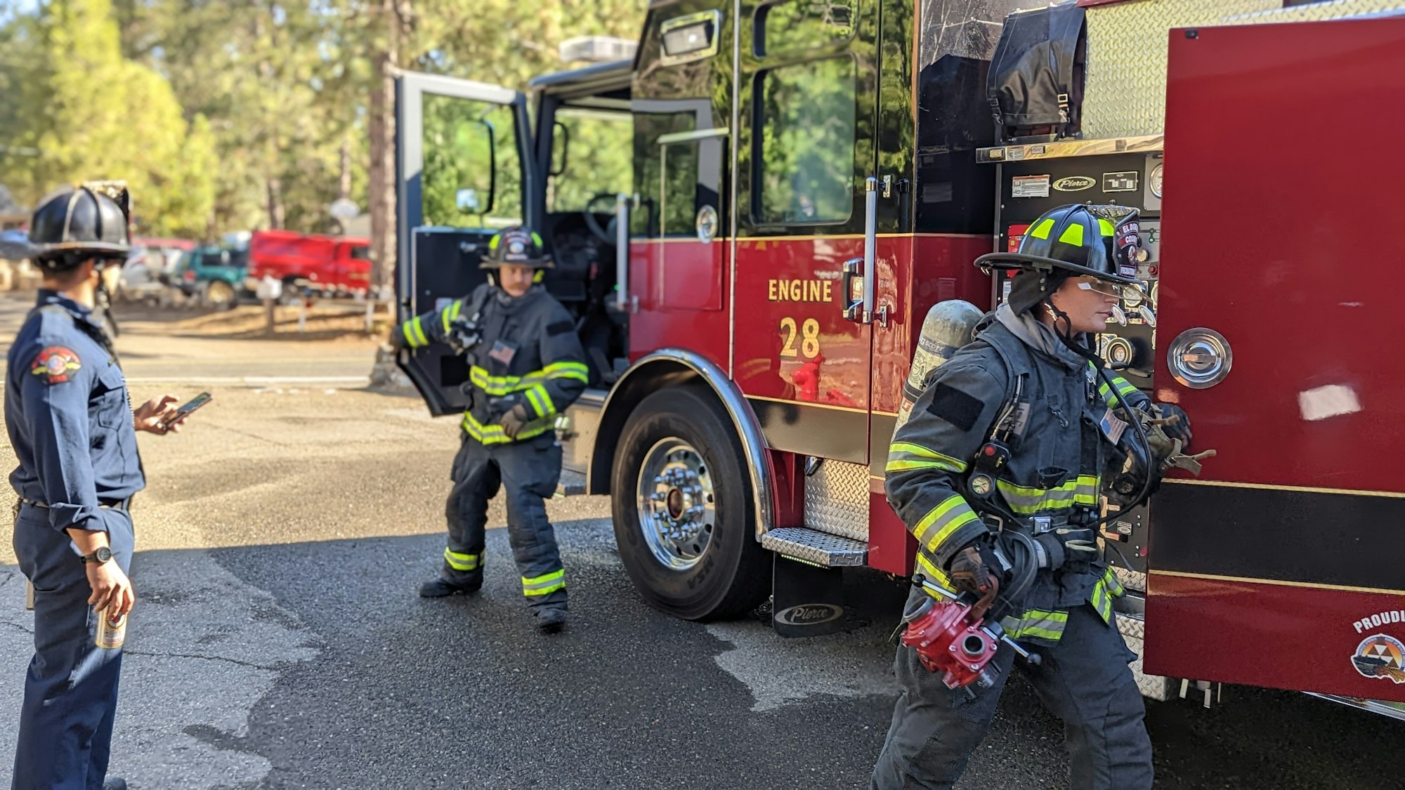May contain: person, human, helmet, clothing, apparel, fireman, truck, transportation, and vehicle