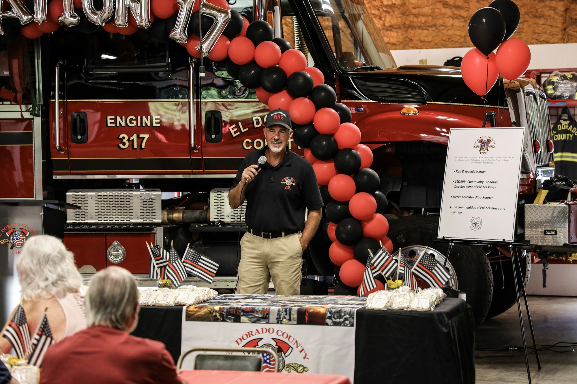 May contain: adult, female, person, woman, male, man, electrical device, microphone, people, balloon, accessories, belt, clothing, hat, bag, handbag, and flag