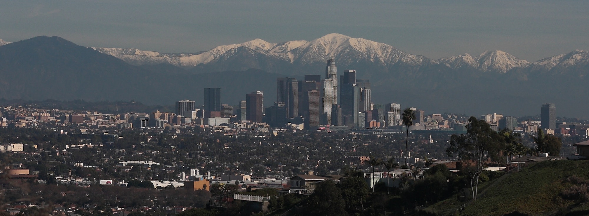 May contain: city, metropolis, urban, architecture, building, cityscape, outdoors, mountain, mountain range, nature, and peak