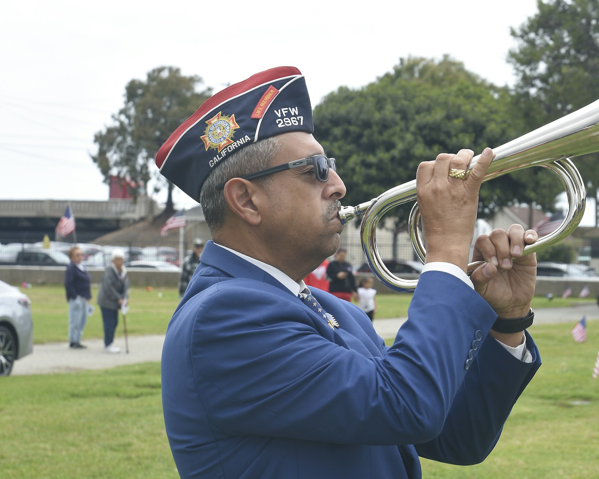 May contain: adult, male, man, person, car, transportation, vehicle, flag, accessories, glasses, brass section, horn, musical instrument, clothing, footwear, shoe, and hat