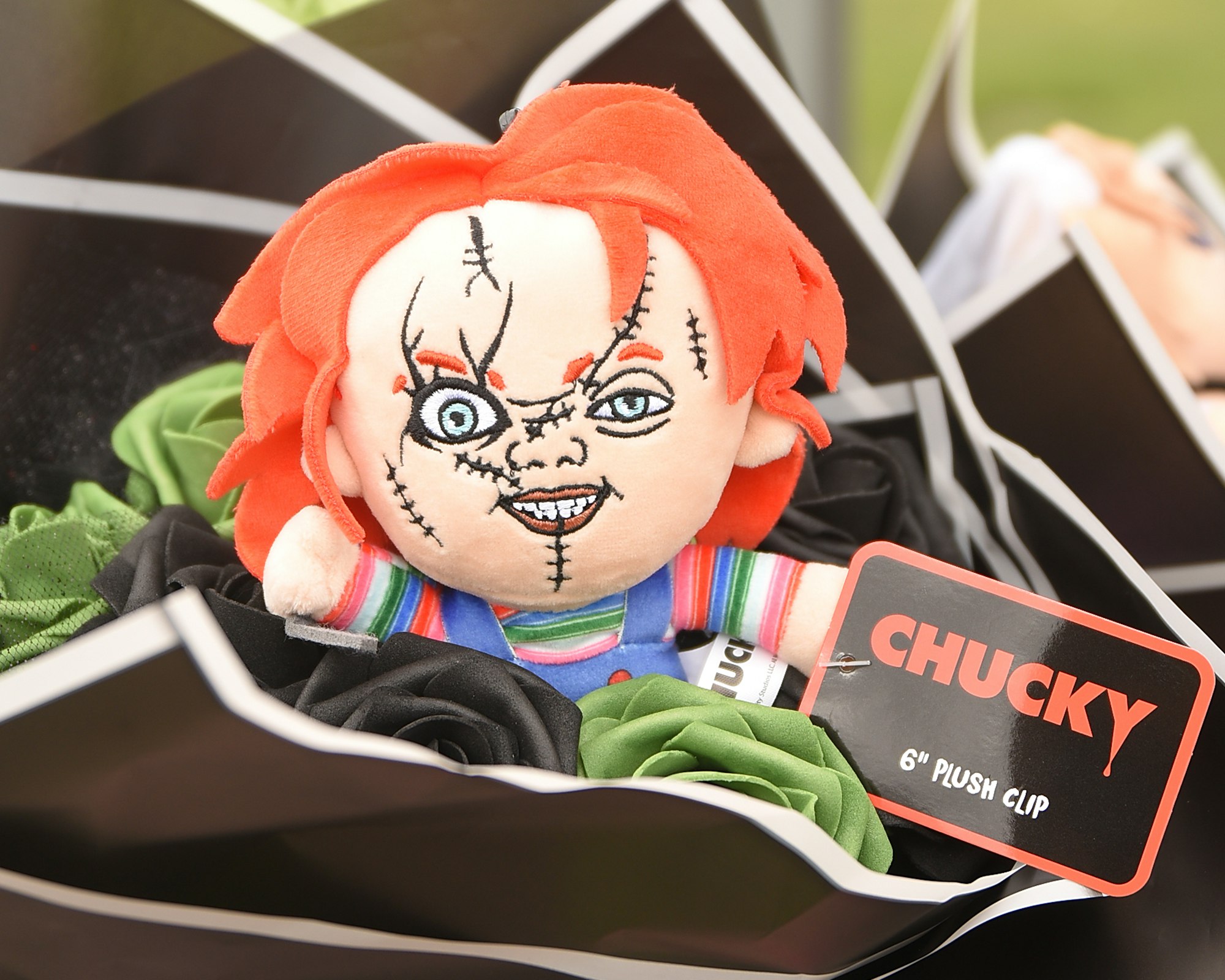 A plush clip of a character with red hair and a striped shirt labeled "CHUCKY".
