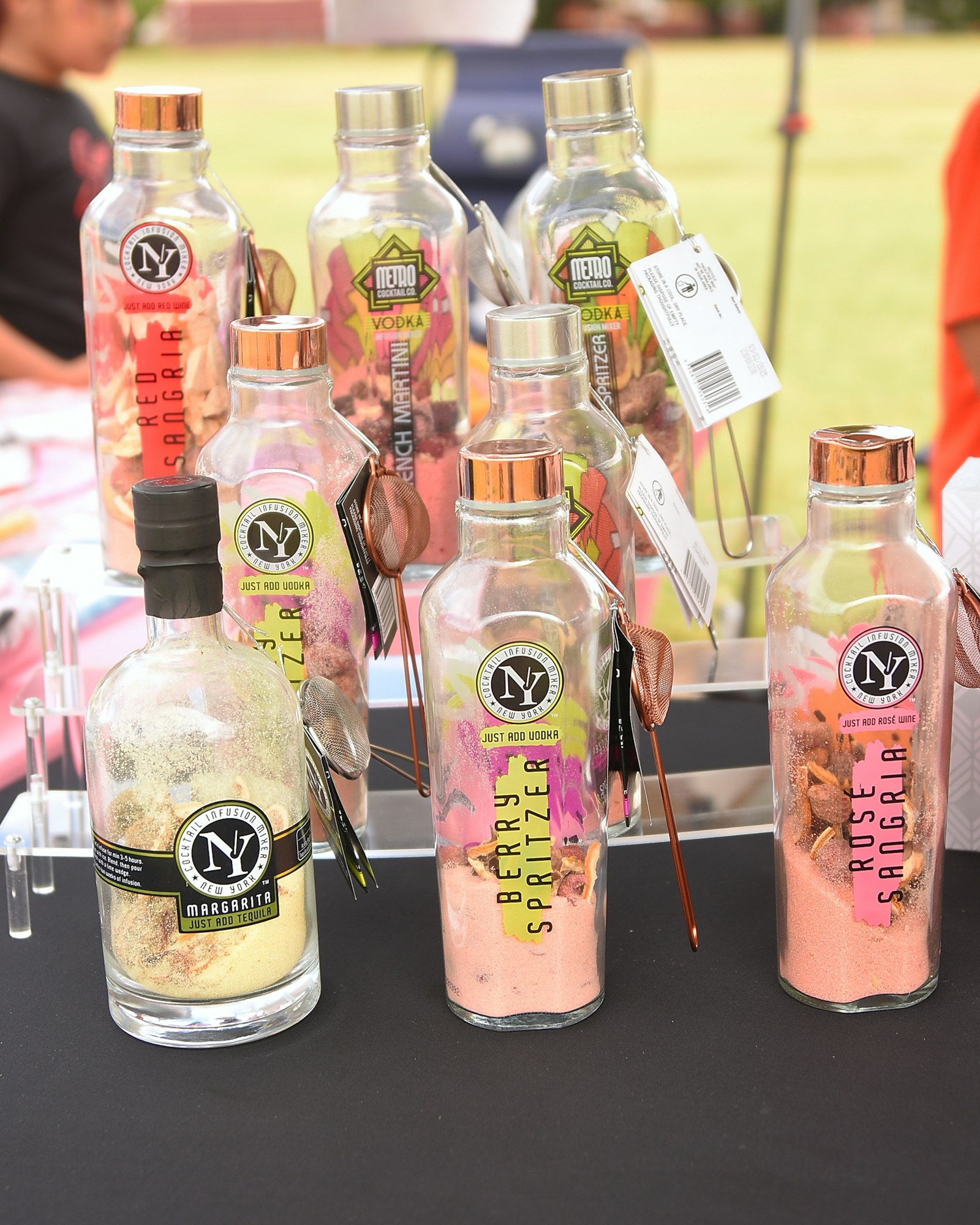 Bottles with cocktail ingredients labeled for specific drinks, just add alcohol.