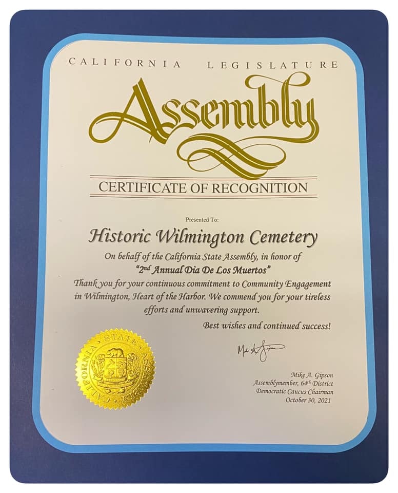 It's a certificate of recognition from the California State Assembly awarded to Historic Wilmington Cemetery for their community engagement during the 2nd Annual Dia De Los Muertos.