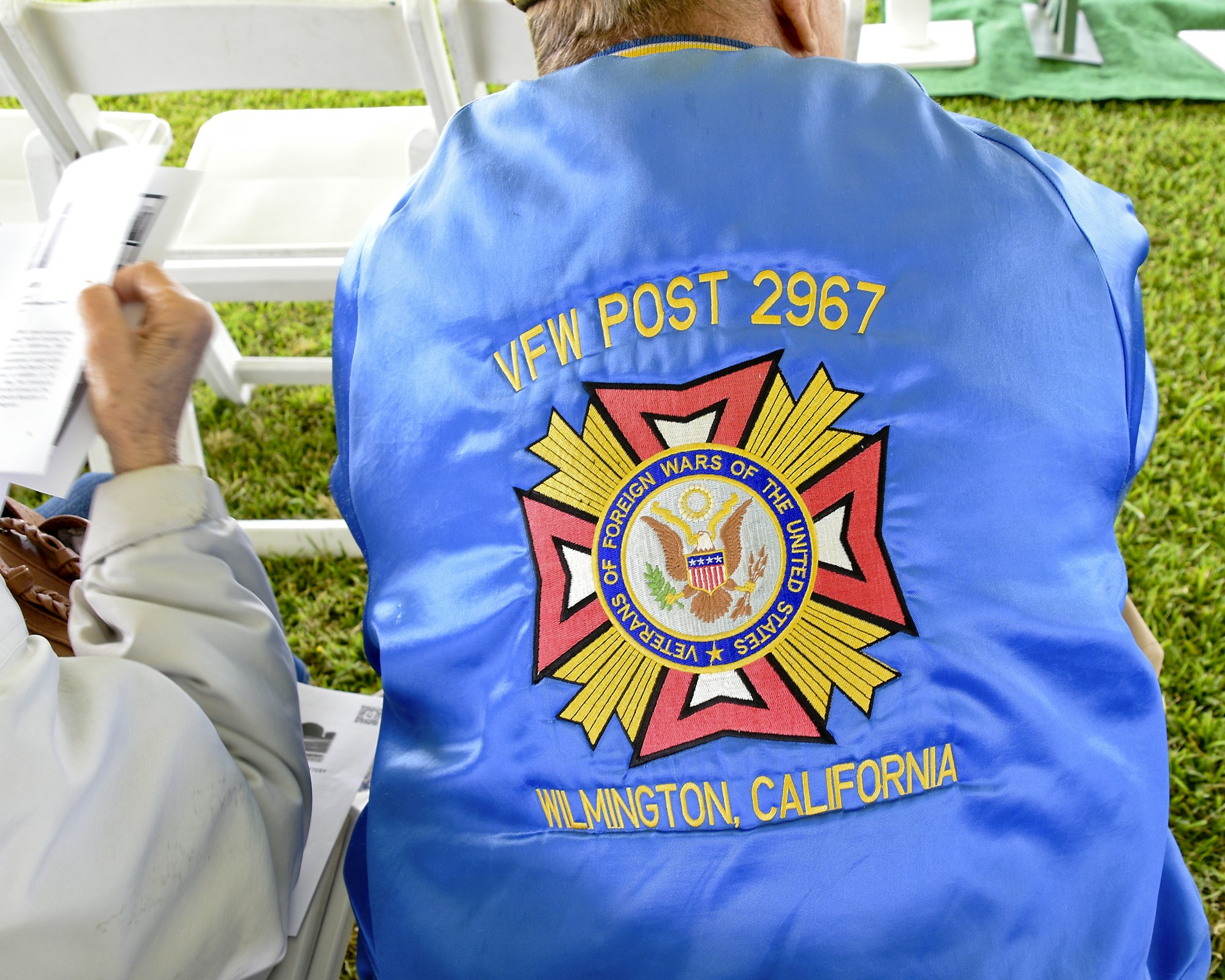 May contain: clothing, shirt, badge, logo, symbol, and person