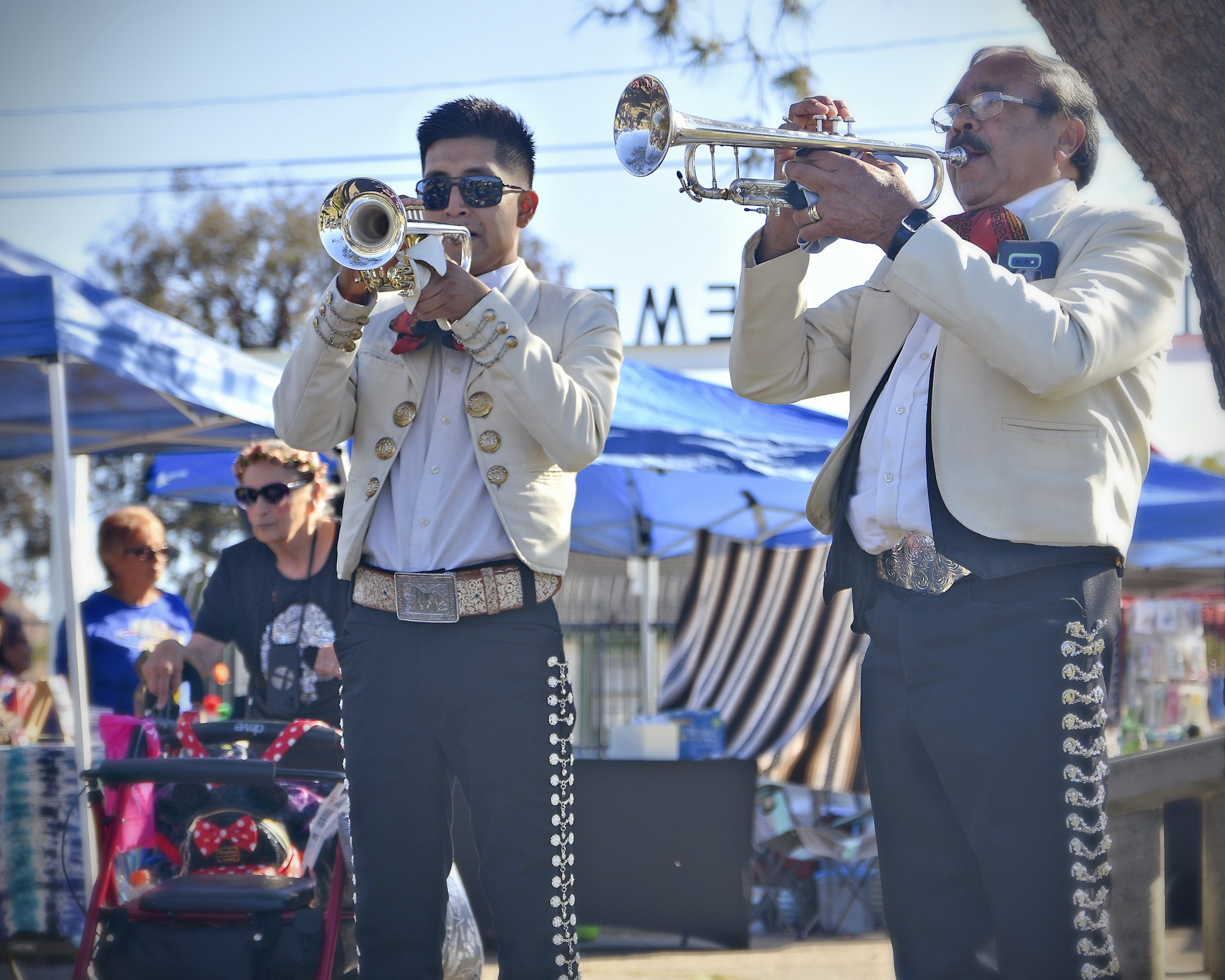 May contain: person, human, sunglasses, accessories, accessory, flugelhorn, brass section, musical instrument, and horn