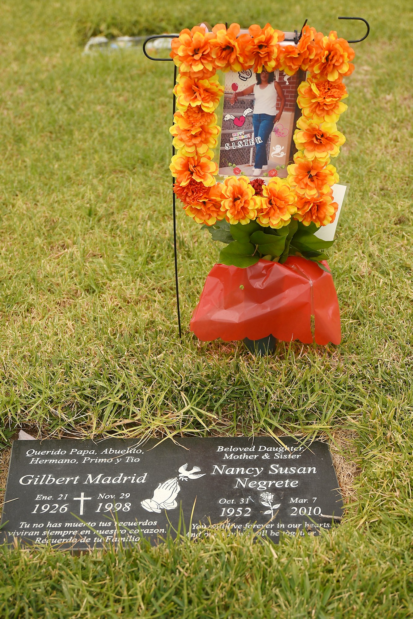 Memorial with flowers and tribute on a grave.