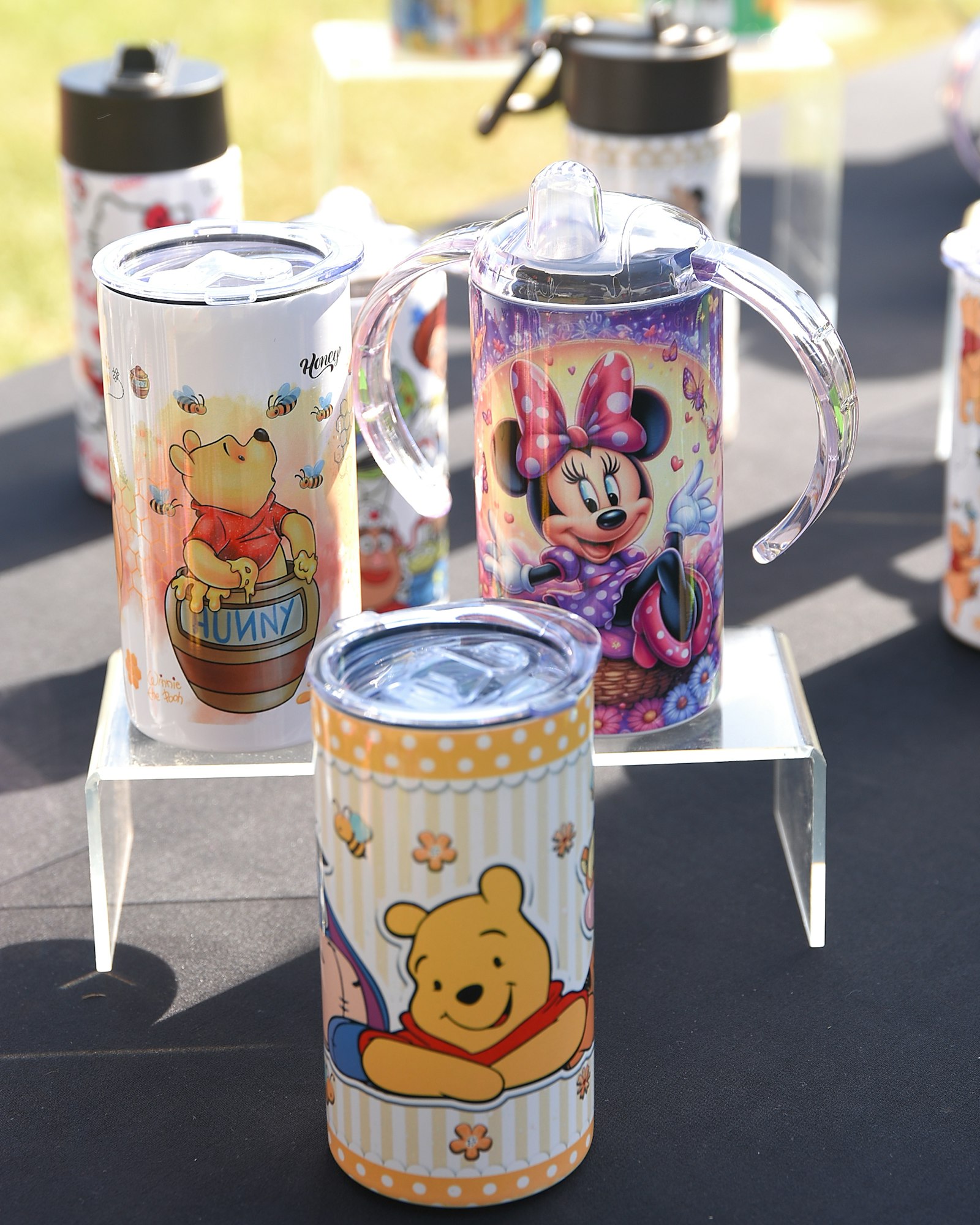 A display of themed tumblers and a pitcher with cartoon prints.