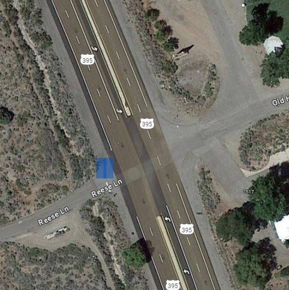 Aerial view of a highway interchange with roads, labeled as "395" and "Reese Ln."
