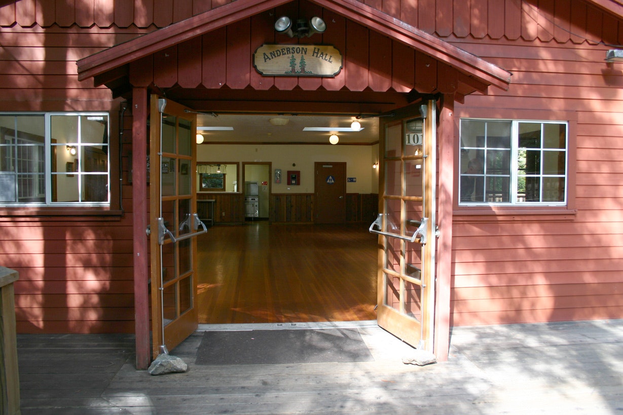 Entrance to "Anderson Hall" with open doors, wooden floors, and interior visible through doorway.