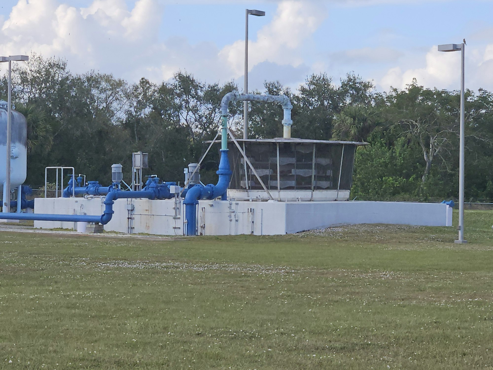 Industrial equipment with pipes and tanks in an outdoor setting.