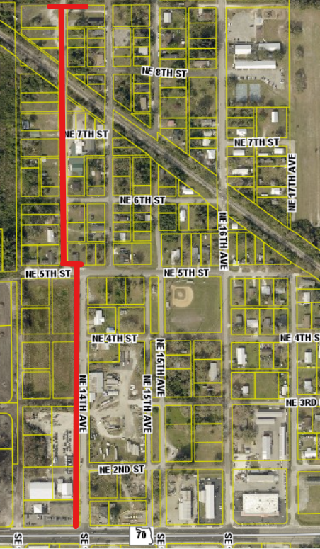 A map showing a grid layout of streets with highlighted routes and various buildings in a residential area.