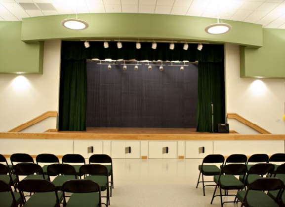 May contain: indoors, room, furniture, chair, auditorium, hall, theater, conference room, and meeting room